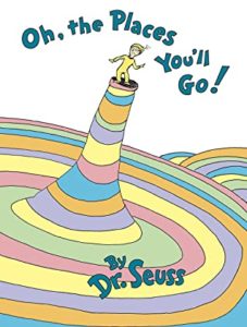 Oh, the Places You'll Go! by Dr. Seuss book cover. Image on cover shows a drawing of a Dr. Seuss character standing on a rainbow top. 