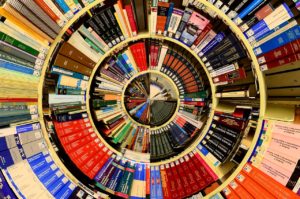 A circular assortment of books on shelves. 