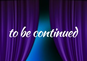 A photo of a purple stage curtain pulled back to reveal a blue, shadowy wall. The text “to be continued” is printed in white over the curtain and the wall. 