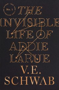 The Invisible Life of Addie LaRue by V.E. Schwab book cover. It’s a typographic cover in black and gold. 