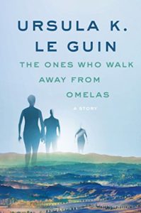 The Ones Who Walk Away from Omelas by Ursula K. LeGuin book cover. Image on cover shows three humanoid figures walking away from the viewer into the sunrise on a flat, grassy plain. 