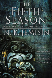 The Fifth Season (The Broken Earth, #1) by N.K. Jemisin book cover. Image on cover shows an ornate metal carving on a door. The carving looks like curled ferns lying on top of each other. 