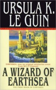 A Wizard of Earthsea (Earthsea Cycle, #1) by Ursula K. Le Guin book cover. Image on cover shows a drawing of a castle with a moat around it. There is a green dragon between the castle and the moat. 