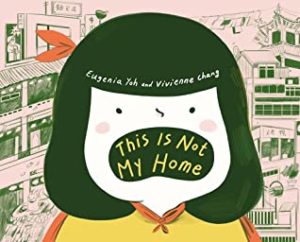 This Is Not My Home by Vivienne Chang book cover. Image on cover shows a drawing of a young Chinese girl wearing a yellow blouse. She’s standing on a balcony and you can see other apartment buildings in the background. Her mouth is open, and inside of her mouth is the title of the book in yellow letters. 