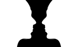 The white portion of the image looks like side profiles of two people looking at each other. The black portion of the image looks like a vase. You decide which one you think it should be!
