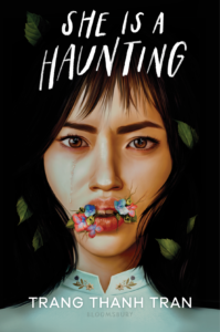 Book cover for “She Is a Haunting” by Trang Thanh Tran. Image on cover shows a young Vietnamese woman with thick black hair. She looks frightening and is staring straight ahead at the audience crying as six small flowers grow out of her mouth. 