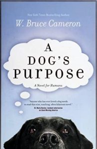 Book cover for A Dog's Purpose (A Dog's Purpose, #1) by W. Bruce Cameron. Image on cover shows a black Labrador retriever looking up from the bottom of the cover as he stands against a light blue background. A thought bubble above his head includes the title of the book.