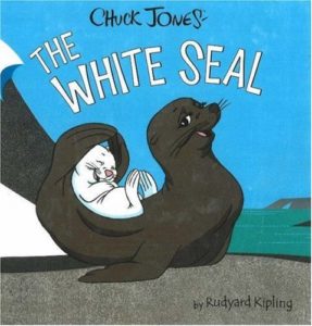 Book cover for  The White Seal by Rudyard Kipling. Image on the cover is a drwaing of a black seal cradling a baby h white seal on his or her back as they lie on a grey beach next to a grassy field. 