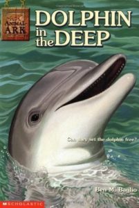 Book cover for Dolphin in the Deep by Lucy Daniels and Ben M. Baglio. Image on cover is a photorealistic painting of a dolphin poking it’s head out of the ocean.