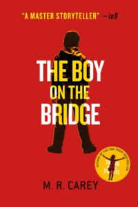 Book cover for The Boy on the Bridge (The Girl With All the Gifts, #2) by M.R. Carey. Image on cover shows a drawing of the back side of a teenage boy who is wearing baggy pants and a hoodie. He is slightly slouched over and has his back turned to the audience. 