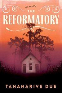 Book cover for The Reformatory by Tananarive Due. Image on cover shows a drawing of a white shack in a smoky, hazy woods just as twilight hits and the world begins to become black. 