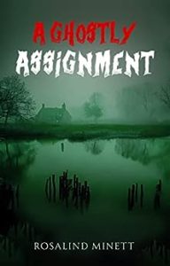 Book cover for A Ghostly Assignment by Rosalind Minnet. Image on cover shows an old-fashioned, small stone cottage near a large, still lake on a foggy autumn day. The trees are bare and you can’t see the sun because of how thick the fog and clouds are. 