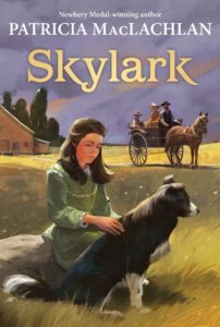 Book cover for Skylark (#2 in the Sarah Plain and Tall Series series) by Patricia MacLachlan. Image on cover is a painting of Anna, the little white girl who is the protagonist of this series, sitting sadly and petting her dog. She is wearing a green 1800s style prairie dress. Her dad, stepmother, and little brother are sitting in a wagon and looking at her from the background. The horse is about to take the stepmother and children away from the drought, but Sarah doesn’t want to go. All around them is dead grass, and there is a barn and a few green trees in the distance. 