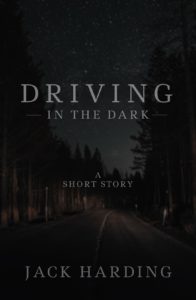 Book cover for Driving in the Dark by Jack Harding. Image on cover shows a dark country road from the perspective of someone driving on it at night. You can just barely make out the road, the pine trees on either side of the road, and the starry night sky above. It is all very, very dark as if this is set in a very rural area where few people drive. 