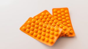 Photo of orange blister packs filled with pills. 