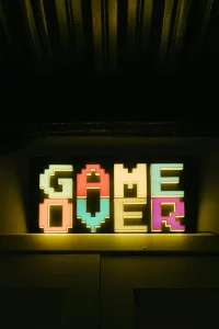 The phrase Game Over is written in bright neon lights. 