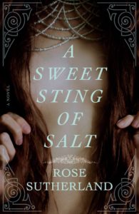 Book cover for A Sweet Sting of Salt by Rose Sutherland. Image on cover shows a closeup of a person’s chest. The person has long, straight brown hair that is covering much of their chest. 
