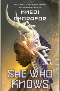 Book cover for She Who Knows: Firespitter by Nnedi Okorafor. Image on cover shows a drawing of an African woman who is wearing an animal skull and vertebrae as a hat. Golden light is shining on her face. 