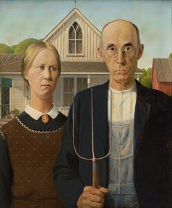 The painting American Gothic by Grant Wood. This was created in 1930 and features two stern-looking white people who are standing in front of their farmhouse looking grumpy. The man is holding a pitchfork and wearing a white shirt and black jacket. The woman is wearing a black dress with a white collar, a red floral apron, and a little necklace around the collar that looks like the silhoutte of a person’s face. She has blond hair pulled back into a neat bun. He is mostly bald but has a fringe of grey hair on part of his head. 