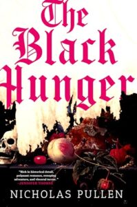 Book cover for The Black Hunger by Nicholas Pullen. Image on cover shows a tabled filled with autumn fruits like apples, some of which are rotten, and a human skull placed on the side of the table. This is an unsettling scene that made me shiver. 