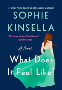 Book cover for What Does It Feel Like by Sophie Kinsella. Image on cover is a drwaing of a white woman with long, straight light brown hair who is wearing a fluffy turquoise gown that has a low-cut back and walking away from the audience. 