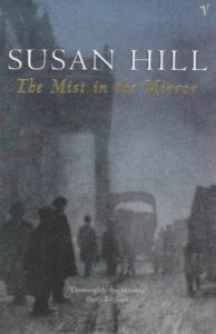 Book cover for The Mist in the Mirror by Susan Hill. Image on cover shows a painting of several people walking down a town street on a very foggy day. You can’t see any identifying features for anyone, just their long, dark coats and the outlines of their heads. You can also see a horse pulling a carriage down the street but they, too, are distorted and blurred out by the thick and unyielding fog that makes everything look grey. 