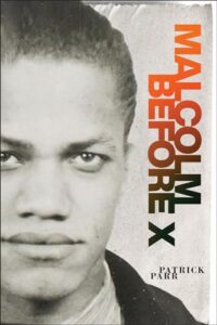 Book cover for Malcolm Before X by Patrick Parr. Image on the cover is a black and white photograph of a young Malcolm X staring thoughtfully ahead at the viewer. 