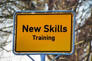 A light orange sign that says “new skills training”. 