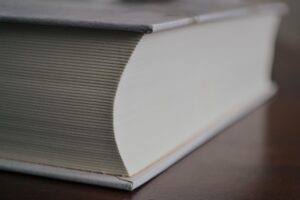 Closeup of a huge hardback book. It looks like it has 800+ pages in it. 