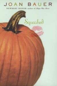 Book cover for Squashed by Joan Bauer. Image on cover shows pumpkin as well as the imprint of lipstick on the pumpkin and cover. 