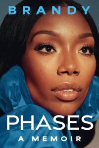 Book cover for Phases: a Memoir by Brandy Norwood. Image on cover is a close-up photo of her face as she wears a blue silk garment and gazes thoughtfully off into the distance.