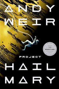 Book cover for Project Hail Mary by Andy Weir. Image on cover is a drawing of an astronaut falling through space with a large yellow planet in the background. The astronaut is stilll tethered to something just out of sight by a white cord attached to their space suit, but their limbs are flailing as they are unable to grasp onto anything in the vacuum of space. 