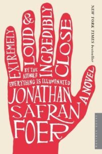 Book cover for Extremely Loud & Incredibly Close by Jonathan Safran Foer. Image on cover is a red handprint that has the title and author’s name written in white ink on all five fingers and on the palm of the hand. Very creative!