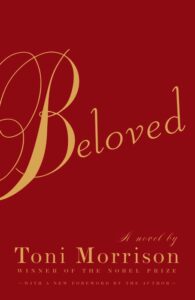 Book cover for Beloved (Beloved Trilogy, #1) by Toni Morrison. The word Beloved is written in an elegant gold font against a red background. 