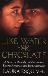 Book cover for Like Water for Chocolate by Laura Esquivel. Image on cover shows the faces of two Mexican people, one woman and one man, leaned in so close that his nose is nearly touching her cheek. 