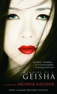 Book cover for Memoirs of a Geisha by Arthur Golden. Image on cover shows a closeup shot of a Geisha who is starting ahead at the viewer with a serious expression on her face. 