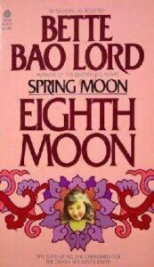 Book cover for Eighth Moon: The True Story of a Young Girl's Life in Communist China by Bette Bao Lord. Image on cover shows a drawing of an arrange of purple flowers surrounding the face of a young Chinese woman, presumably the author.