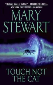 Book cover for Touch Not the Cat by Mary Stewart. Image on cover shows a cat confidently walking into what appears to be a wormhole. 
