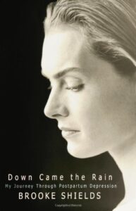 Book cover for Down Came the Rain: My Journey Through Postpartum Depression by Brooke Shields. Image on cover shows Brooke Shields face from the side. She’s looking down with a solemn expression on her face. 