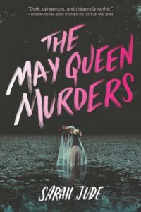 Book cover for The May Queen Murders by Sarah Jude. Image on cover shows a young white woman wearing a white floral crown and a bridal veil who is chest-deep in a body of water at night. This scene made me shudder. She looks scared!