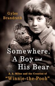 Book cover for Somewhere, a Boy and a Bear: A. A. Milne and the Creation of "Winnie-the-Pooh" by Gyles Brandreth. Image on cover shows a black and white photo of the young boy whose childhood inspired the Winnie the Pooh stories.