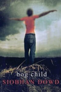 Book cover for Bog Child by Siobahn Dowd. Image on cove shows a blurry painting of a child wearing an orange shirt and blue jeans who is standing in front of a forest with his or her arms stretched out wide.