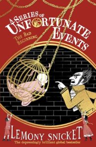 Book cover for The Bad Beginning by Lemony Snicket. Image on cover is a drawing of a small child in a yellow bird cage. There is a man with a large nose pointing his finger at the child and scolding them as he stands outside the cage.