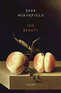 Book cover for The Beauty: Poems by Jane Hirshfield. Image on cover shows a painting of two ripe peaches sitting on a wooden table.