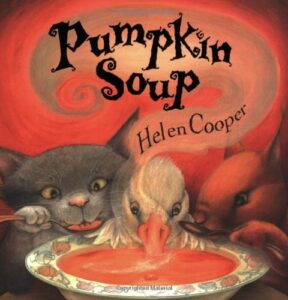 Book cover for Pumpkin Soup by Helen Cooper. Image on cover shows a drawing of a cat, a white duck, and a squirrel sharing a bowl of pumpkin soup together. 
