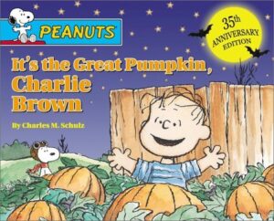 Book cover for It's the Great Pumpkin, Charlie Brown by Justine Korman Fontes. Image on cover shows Charlie Brown, the comic strip character, sitting joyfully in a pumpkin patch after dark. Snoopy the Dog is running around with a scarf and a pair of goggles on his head in the distant meadow. 