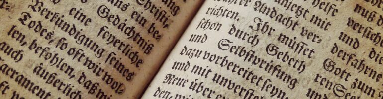 Closeup photo of an antique book printed in Old German. I don’t know what the words say, but the font is beautiful.